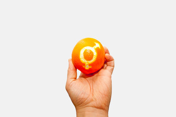 Gender equality. Orange with the sign of gender equality in the hand of a woman. On white background. isolate equality