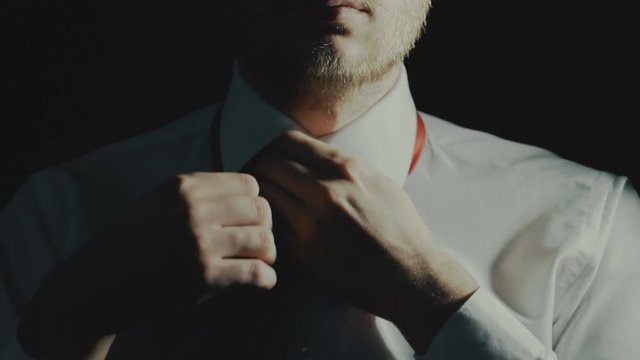 concept businessman or office worker tired after work, male unties tie and undoing button of shirt