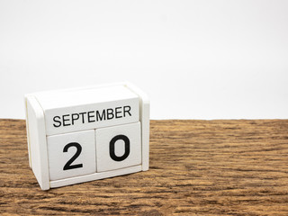 September 20 white cube wooden calendar on vintage wood and white background with autumn day,...