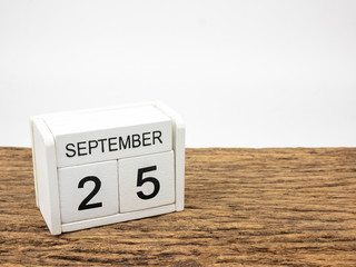 September 25 white cube wooden calendar on vintage wood and white background with autumn day,...