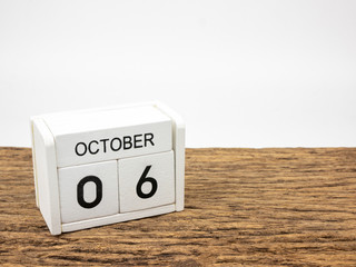 October 6 white cube wooden calendar on vintage wood and white background with autumn day, Copyspace for text