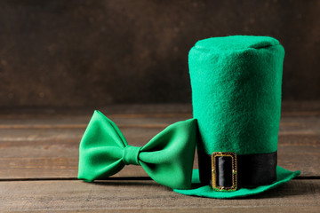 St.Patrick 's Day. celebration. Green leprechaun hat and bow tie on a brown background. space for...