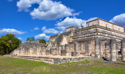 Obraz premium Sunny day with blue sky and white clouds. No people around. Mayan ruin. Templo de Los Guerreros (Temple of The Warriors) in Yucatan, Mexico - Mar 2, 2018