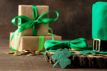 St.Patrick 's Day. celebration. Green leprechaun hat, money, bow tie and clover leaf on a brown...