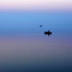 lonely boat in the fog early in the morning