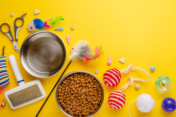 Pet, cat, food and accessories of cat living flat lay, with space for design, on yellow background