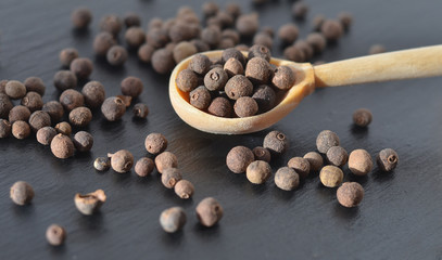 Black pepper in a spoon.