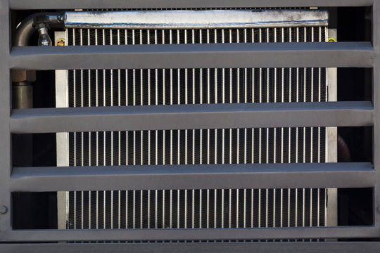 Radiator cooling the engine of the road machinery close-up