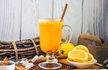 Spice fruit tea in a transparent cup. Tea with pineapple, sea buckthorn, cinnamon, star anise, lemon and sugar
