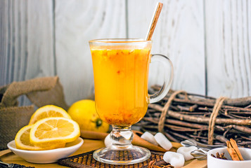 Spice  tea in a transparent cup. Tea with pineapple, sea buckthorn, cinnamon, star anise, lemon and sugar