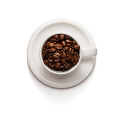 Top View Photo of a Coffee cup filled with coffee beans and saucer isolated on white background