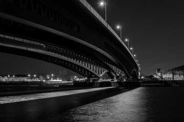 Fototapeta na wymiar Big Bridge at Night, bottom of a Bridge, Bridge Construction, black and white