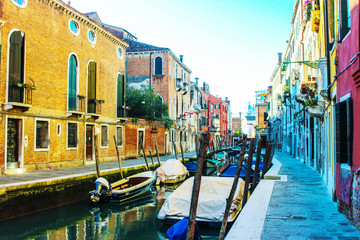 Fototapeta na wymiar Sunny day in Venice. Narrow streets, canals and beautiful architecture.
