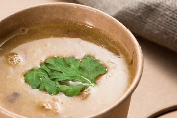 Soup in a disposable cup of craft paper