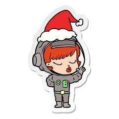 sticker cartoon of a pretty astronaut girl wearing santa hat
