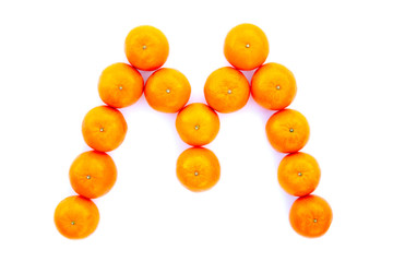 Letter solved with tangerines isolated on white background. Mandarine «M» letter
