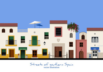 Typical street in southern Spain. Fruit and vegetable store and hotel. Houses with balconies and windows with bars.