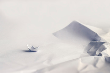 Origami concept. Boat at a rocky bay