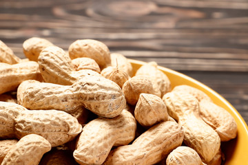 Рeanuts close up on wooden background. Place for text. Top view.