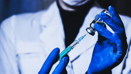 Syringe and hand closeup. The concept of vaccination, filling the drug into the syringe - obrazy, fototapety, plakaty