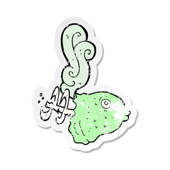 retro distressed sticker of a cartoon smelly old fish head