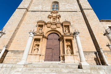 decorated door and facade of Parish of Santa Ana, landmark and public monument from sixteenth century, in main square of Penaranda de Duero village, in Burgos, Castile and Leon, Spain, Europe
