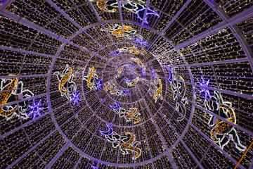 detail of Christmas illumination like a tree with lights and brilliant ornaments, inside view 