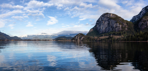 Beautiful panoramic Canadian landscape view of a popular landmark, Chief Mountain, during a cloudy sunny day. Taken in Squamish, North of Vancouver, BC, Canada.