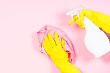 Woman cleaning pink surface.