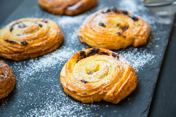 French pastry bun rolls with raisins and vanilla. Pain aux raisins, fresh pastry rolls, french bakery desserts