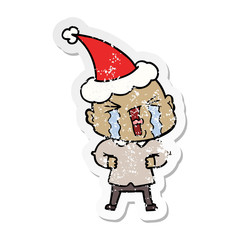 distressed sticker cartoon of a crying bald man wearing santa hat