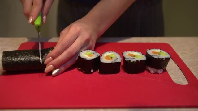 Close up of a woman preparing homemade sushi