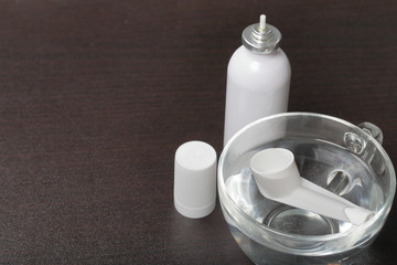 Inhaler for the treatment of respiratory organs. Spray can and cap white. The tip is soaked in...