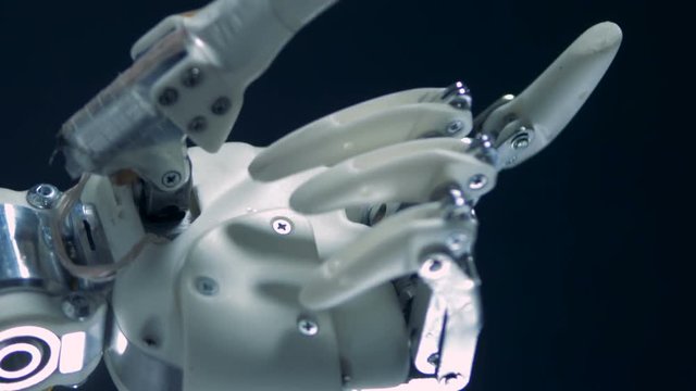 Cybernetic prosthesis works, moving metal fingers.
