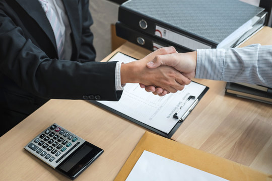 Handshake after finishing conversation Businessman sending a resignation letter to employer boss in order to resign dismiss contract, changing and resigning from work concept