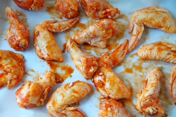 Raw chicken wings with garlic sauce