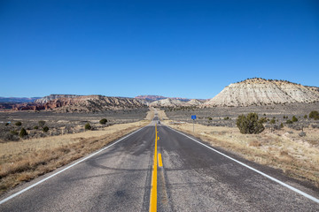Fototapeta na wymiar Scenic road in the desert during a vibrant sunny day. Taken on Route 12, Utah, United States of America.