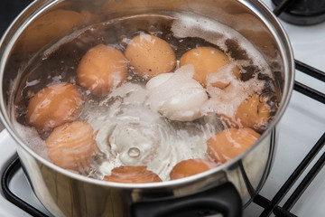 cooking Eggs in boiling water in pan Top view