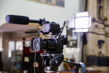 Shooting a report in the interior. Video equipment: camera, on-camera microphone gun, led lighting device, tripod.