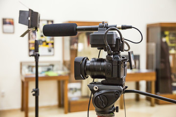 Shooting a report in the interior. Video equipment: camera, on-camera microphone gun, led lighting device, tripod.