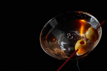 Martini cocktail with green olives.
