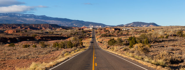 Scenic road in the desert during a vibrant sunny sunrise. Taken on Route 24 near Torrey, Utah,...