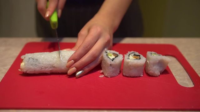 Close up of a woman preparing homemade sushi