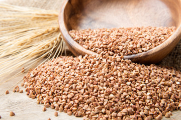 Bowl with Buckwheat on a wooden background