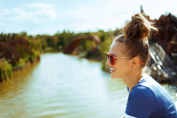 solo traveller woman exploring countryside while having river cr