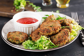 Home made Fish Cake cod, spinach and breadcrumbs. Served on plate with sauce. Cutlets from minced cod. Delicious and nutritious lunch or dinner.