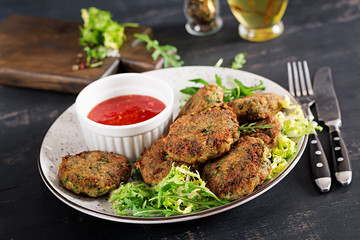 Home made Fish Cake cod, spinach and breadcrumbs. Served on plate with sauce. Cutlets from minced cod. Delicious and nutritious lunch or dinner.