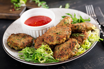 Home made Fish Cake cod, spinach and breadcrumbs. Served on plate with sauce. Cutlets from minced cod. Delicious and nutritious lunch or dinner.