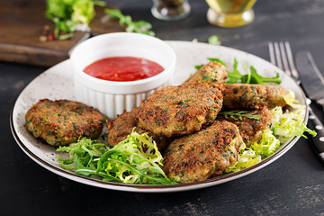 Home made Fish Cake cod, spinach and breadcrumbs. Served on plate with sauce. Cutlets from minced cod. Delicious and nutritious lunch or dinner.