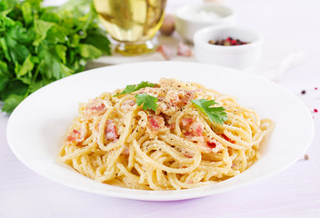 Classic homemade carbonara pasta with pancetta, egg, hard parmesan cheese and cream sauce. Italian cuisine. Spaghetti alla carbonara.